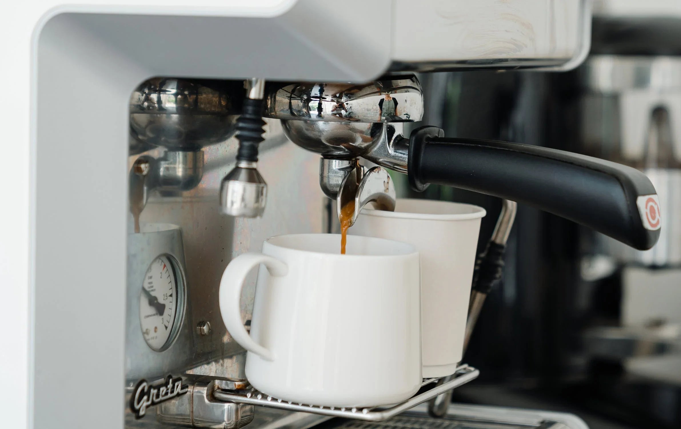 How Home Coffee Machines Upgrade Your Daily Coffee Ritual with espresso pouring into white mugs.