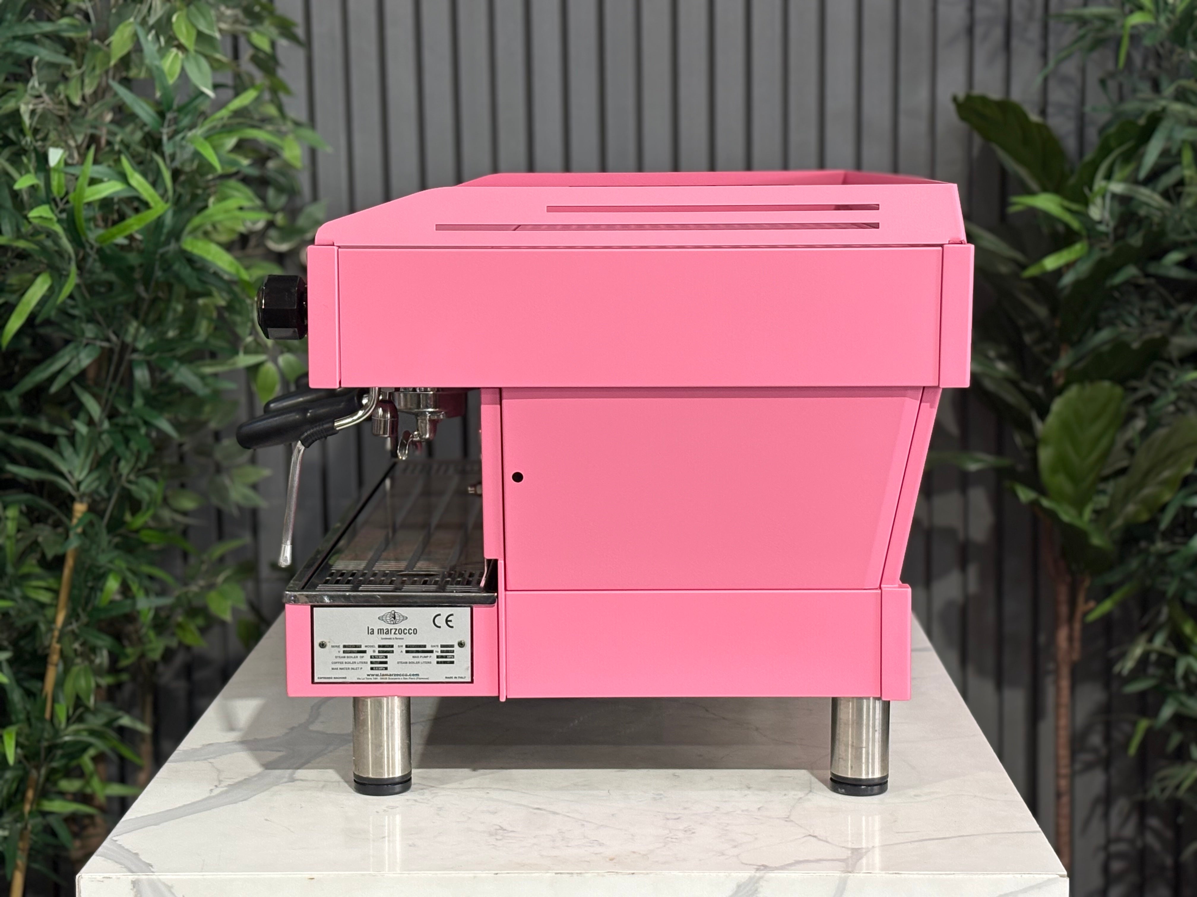 La Marzocco Linea PB 3 Group Coffee Machine Dark Pink - Used displayed on a marble surface with plants in the background.