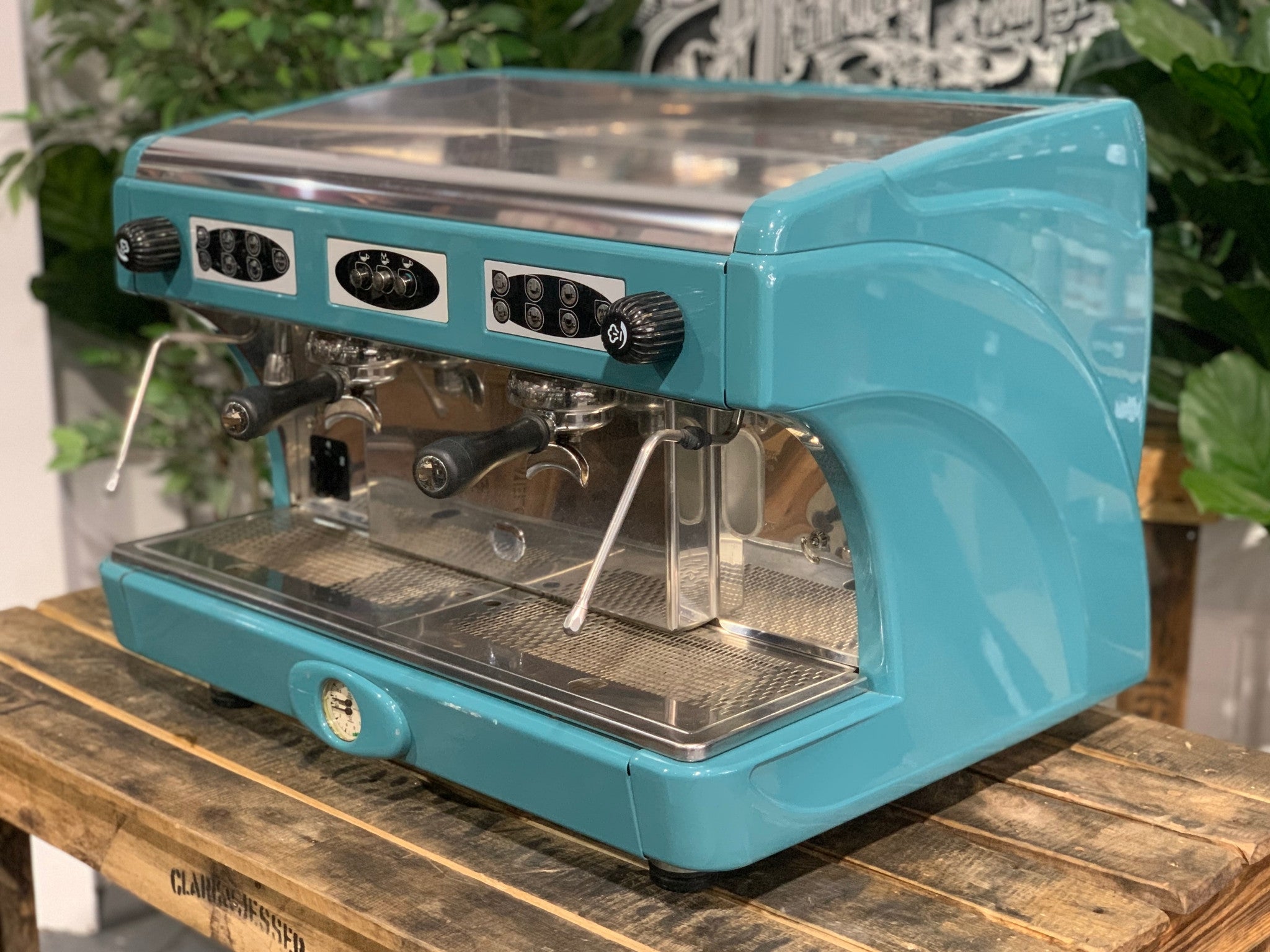 Astoria Calypso 2 Group Aqua Espresso Coffee Machine sitting on a wooden bench. Side on image