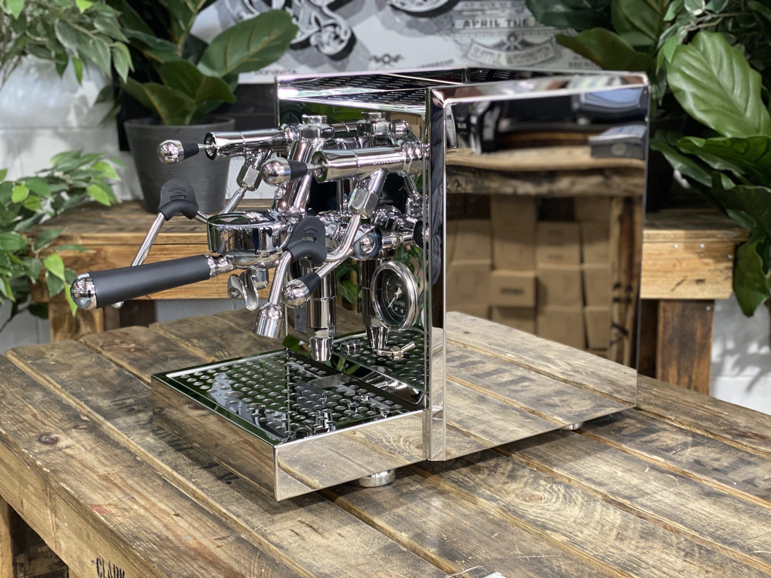 Bellezza Gulia Lever 1 Group Stainless Espresso Machine - New displayed on a wooden table surrounded by greenery.