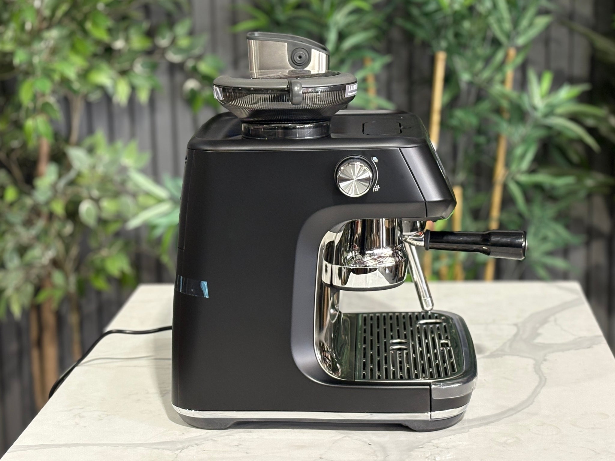 Breville Oracle Jet 1 Group Coffee Machine Black - New, side view on a marble bench, highlighting the black body and AutoMilQ milk steamer wand.