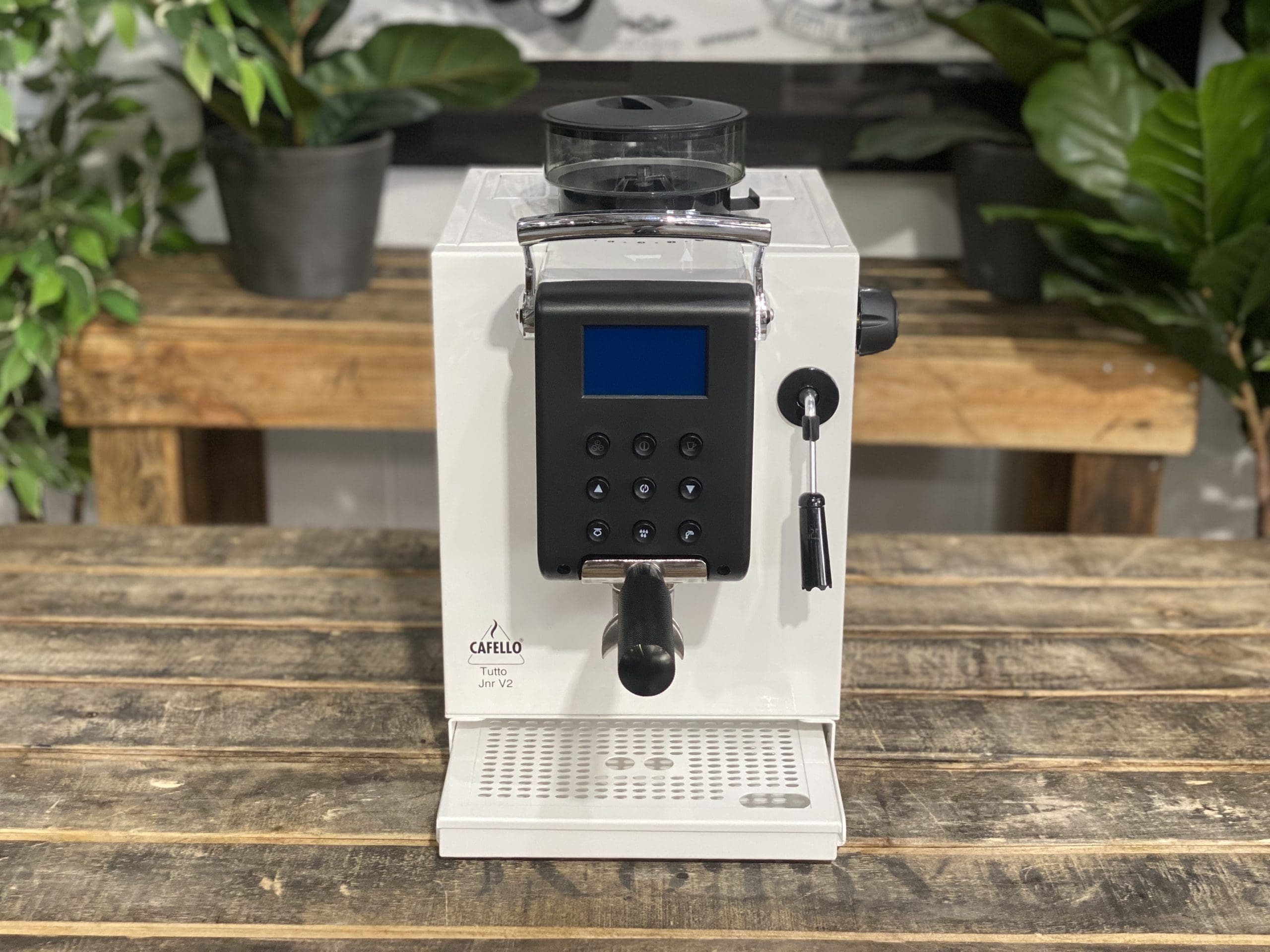 Cafello Tutto Junior V2 Espresso Machine White - New on a wooden table with plants in the background.
