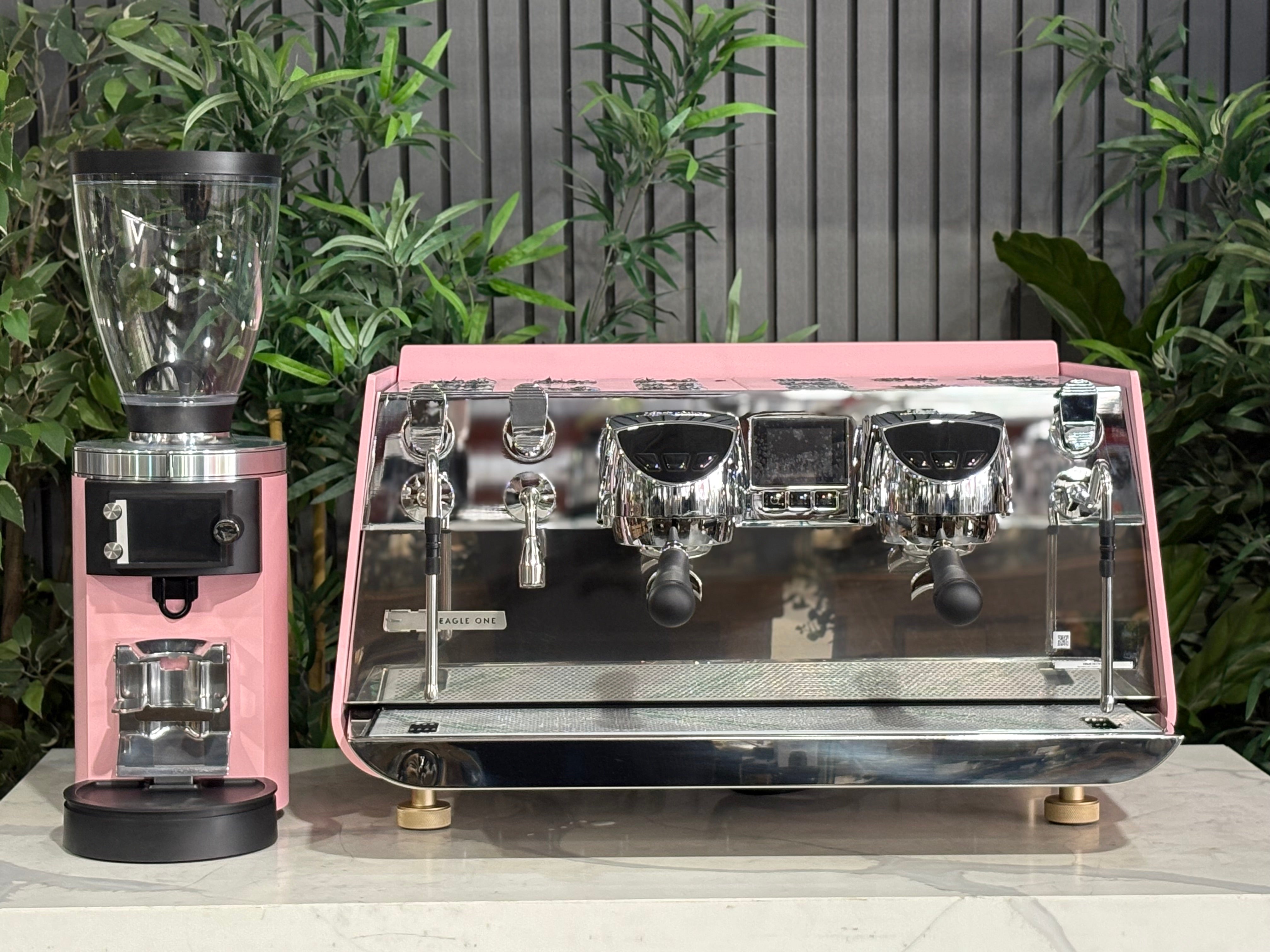 Victoria Arduino Eagle One 2 Group Coffee Machine Custom Pink & Gold with Mahlkönig E65 GBS Grinder on display.