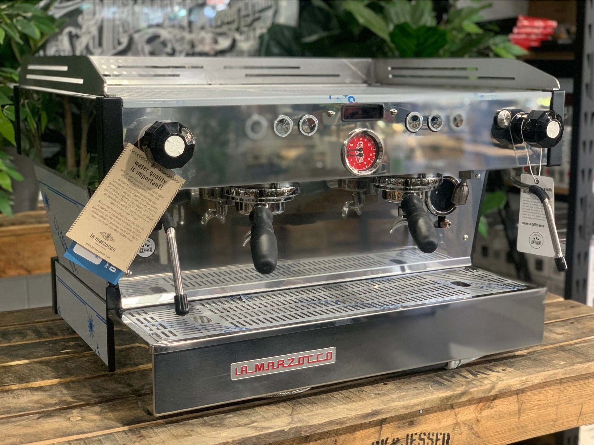 La Marzocco Linea PB 2 Group Coffee Machine Stainless - New angled view showing the stainless steel body, dual group heads with barista lights, dual steam wands, and cup tray.