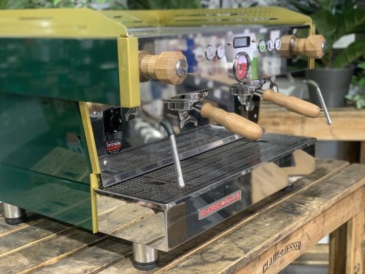 American Oak Steam Knob Set + 2 La Marzocco Style Handles on espresso machine with green exterior design.
