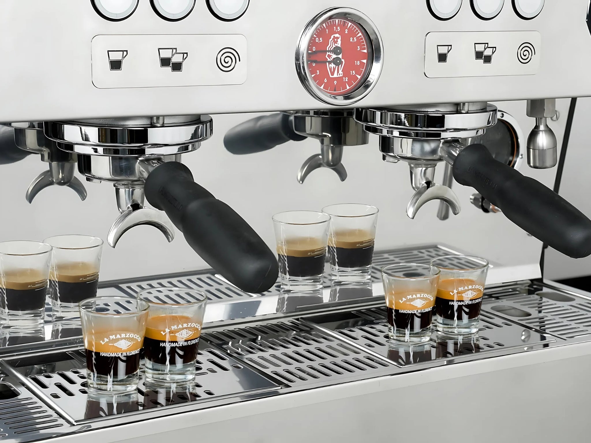 La Marzocco Linea PB ABR 2 Group Coffee Machine Stainless - New close-up of group heads with espresso shot glasses positioned underneath, showing dual steam wands, stainless steel body, and precision espresso features in a full-size image.