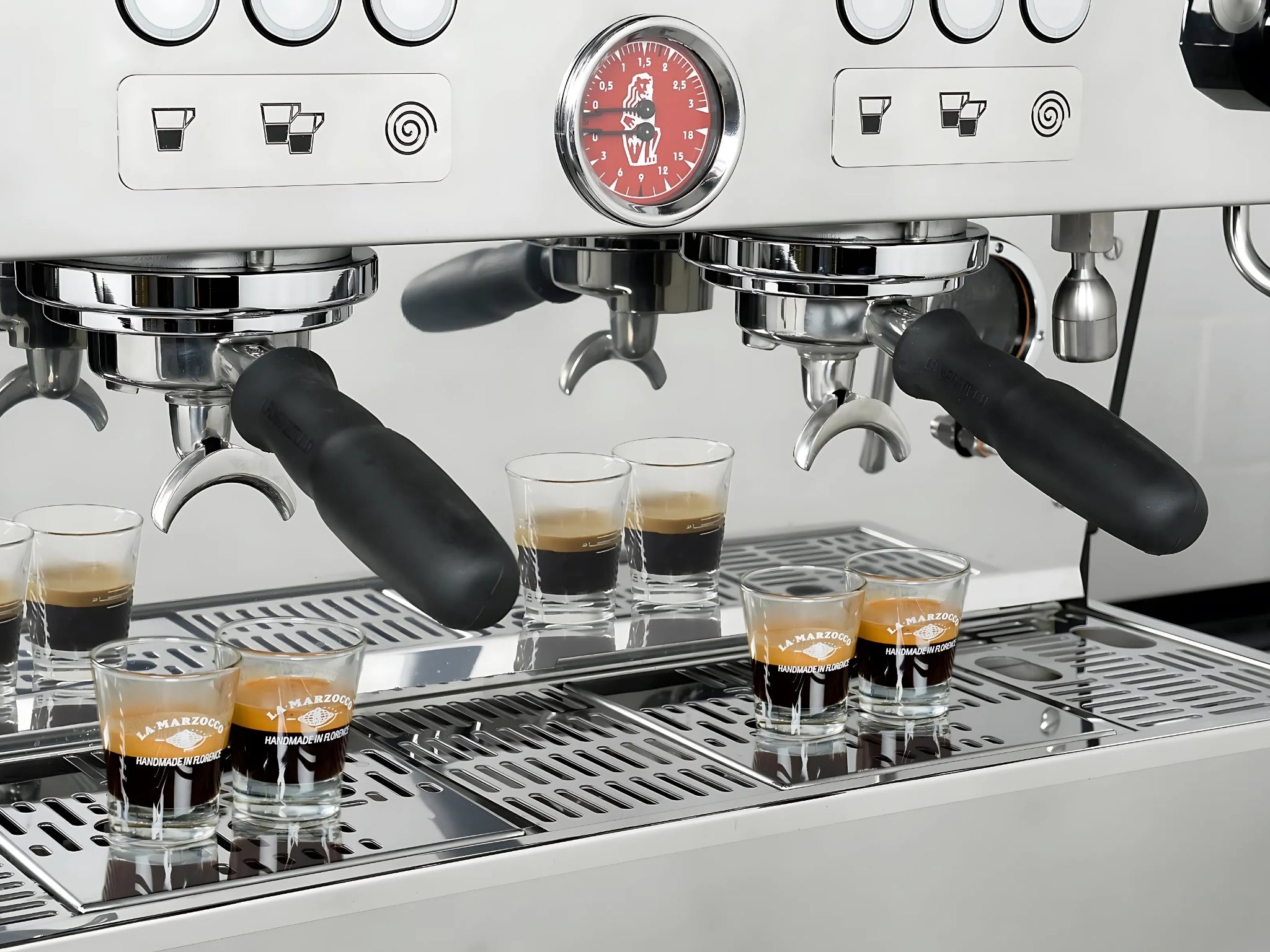 La Marzocco Linea PB ABR 3 Group Coffee Machine Stainless - New close-up of group heads with espresso shot glasses positioned underneath, showing dual steam wands, stainless steel body, and precision espresso features in a full-size image.