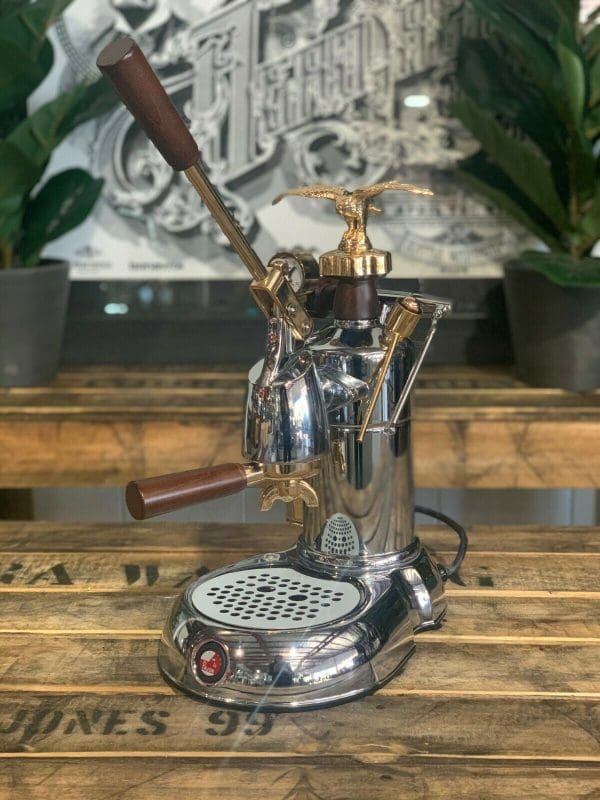 La Pavoni Expo 2015 1 Group Espresso Machine showcasing elegant design and craftsmanship on a wooden table.