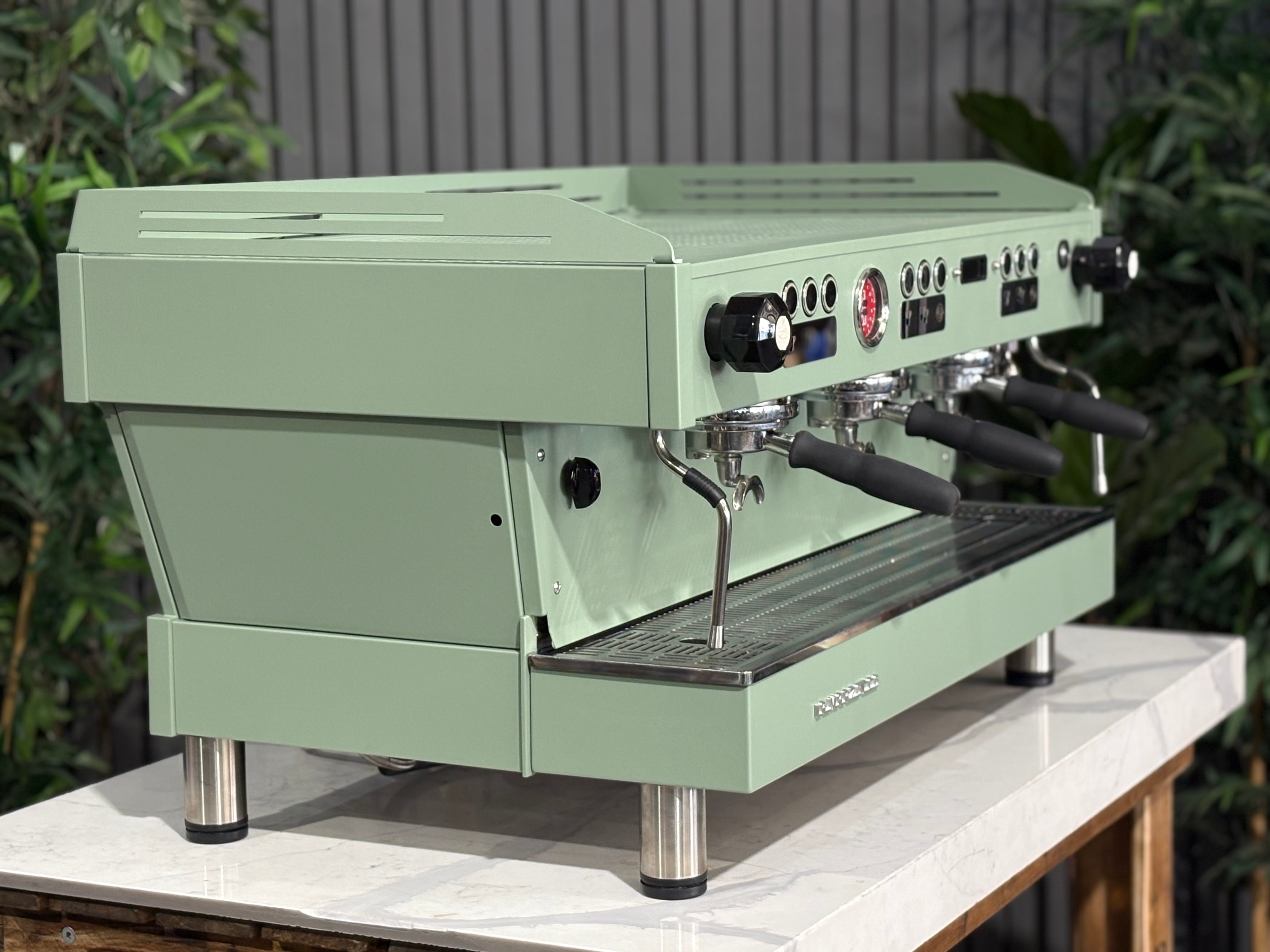La Marzocco Linea PB 3 Group Coffee Machine Mint Green - Used displayed on a white countertop with greenery in the background.