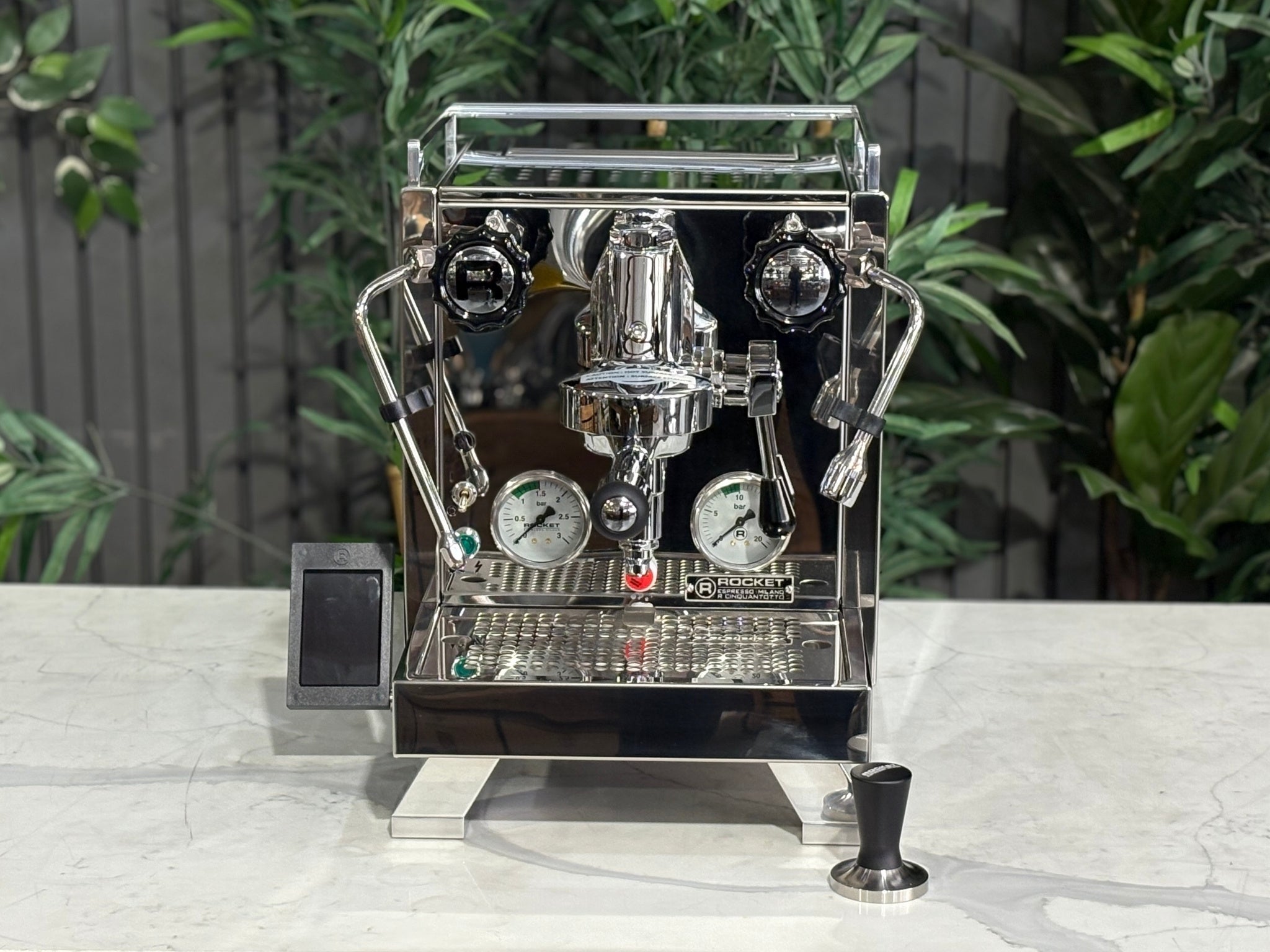 Rocket Cinquantotto R58 1 Group Coffee Machine Stainless - New front-on top view displaying the polished stainless steel body, dual boilers, PID control interface, and water tank on a marble bench with greenery in the background.