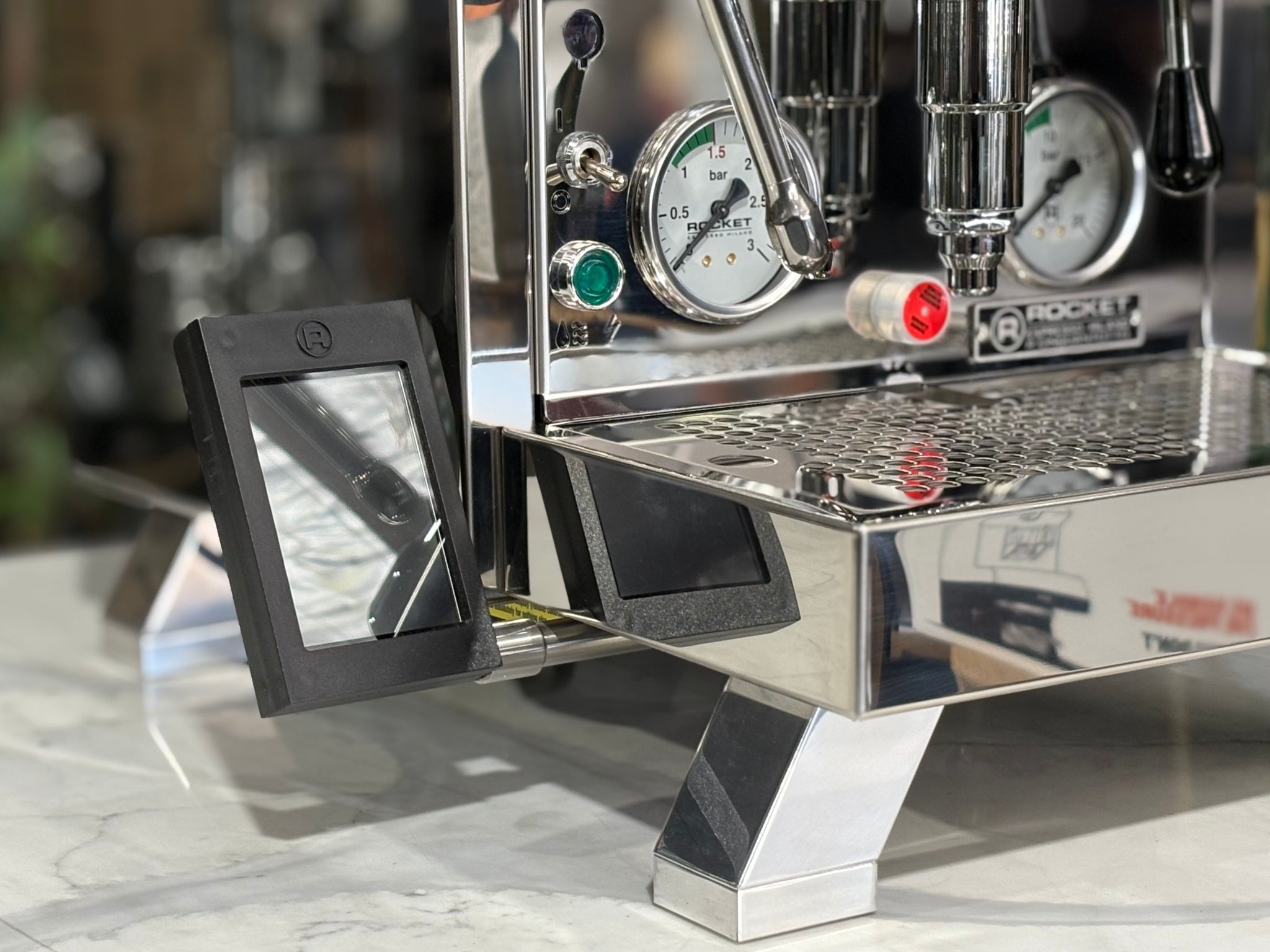 Rocket Cinquantotto R58 1 Group Coffee Machine Stainless - New close-up angled view highlighting the PID temperature control, E61 group head, and polished stainless steel body on a marble bench with greenery in the background, perfect for precise home espresso brewing.