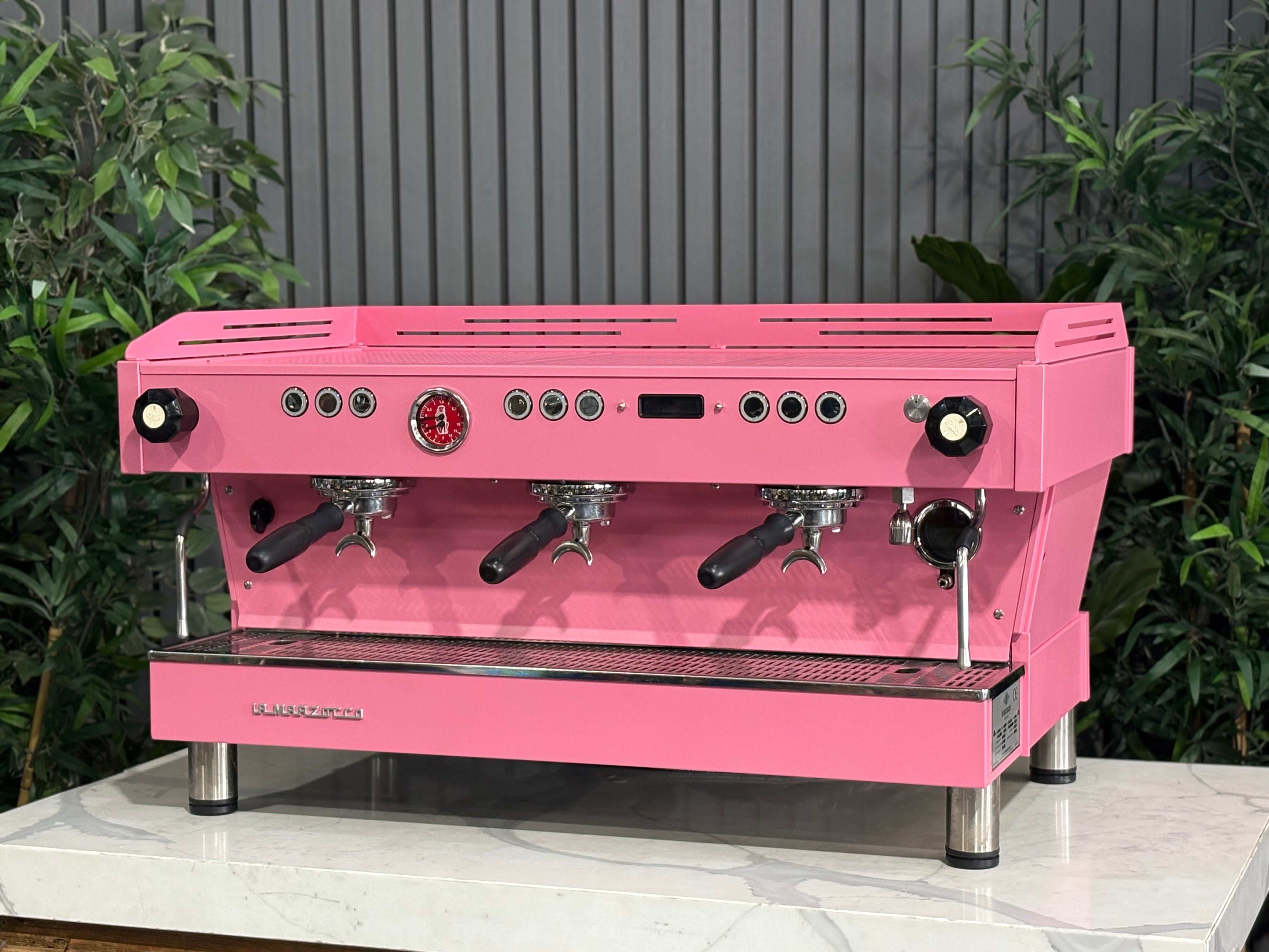 La Marzocco Linea PB 3 Group Coffee Machine Dark Pink - Used on a countertop surrounded by greenery.