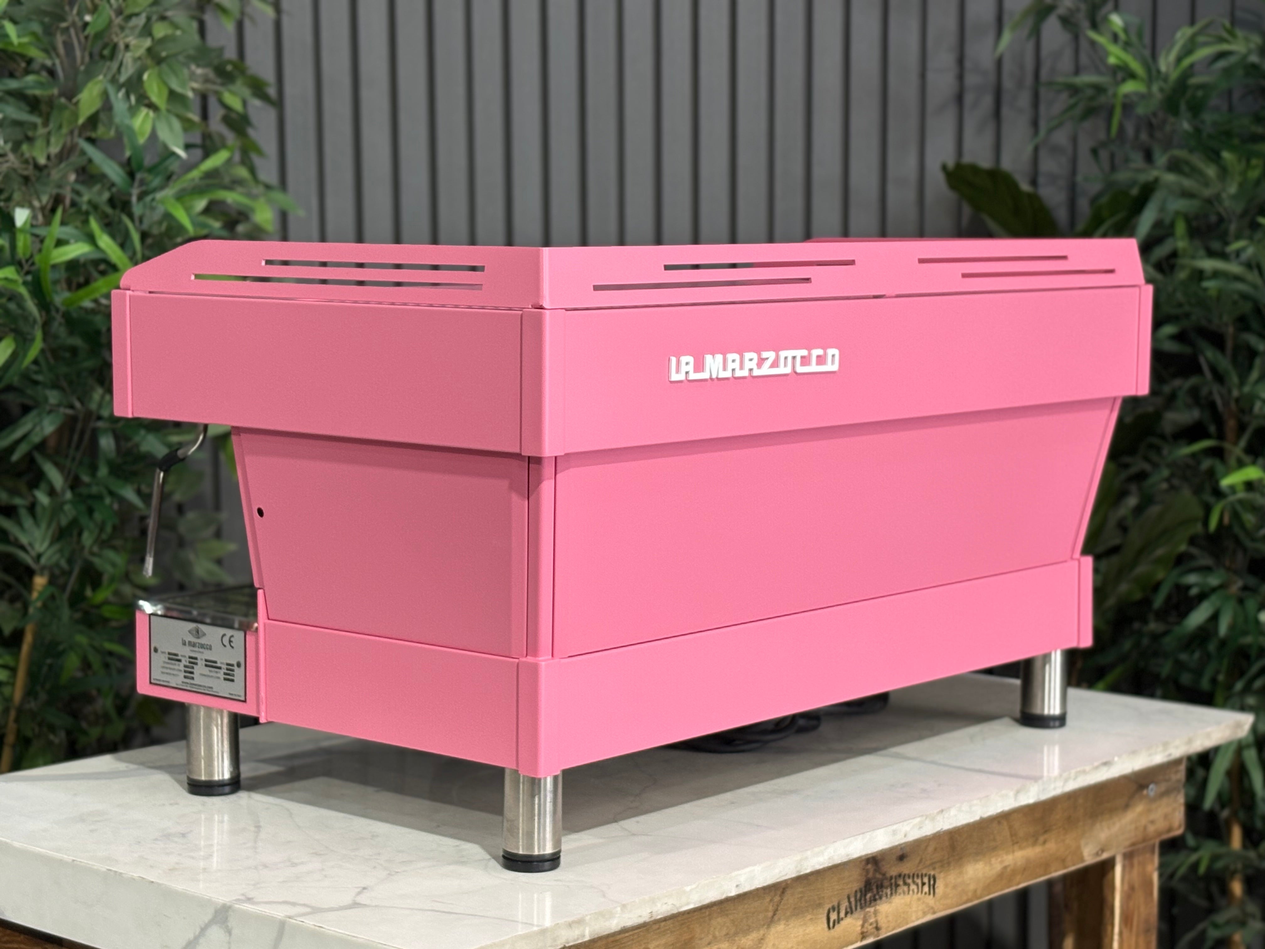 La Marzocco Linea PB 3 Group Coffee Machine Dark Pink - Used on display with greenery in background.