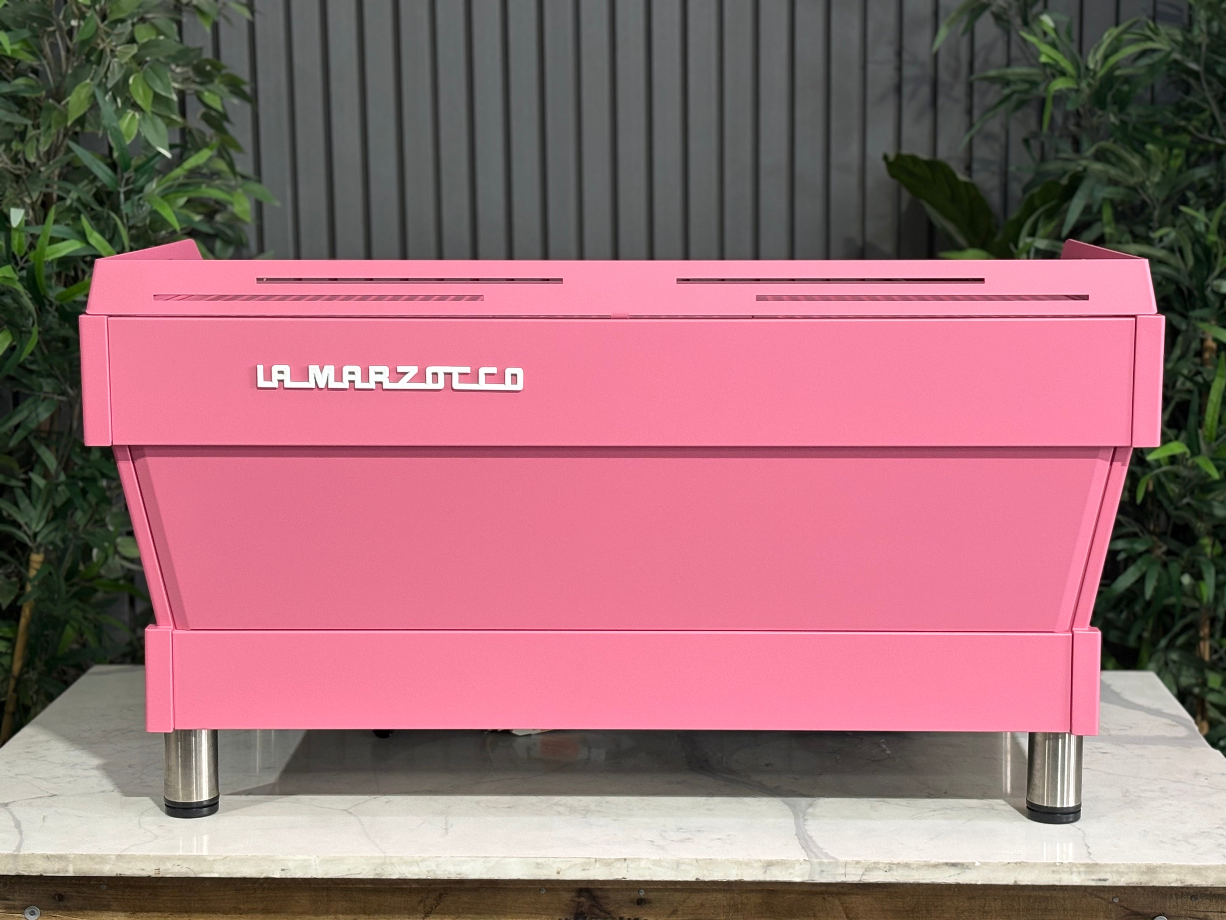 La Marzocco Linea PB 3 Group Coffee Machine Dark Pink - Used on display with green plants in the background.