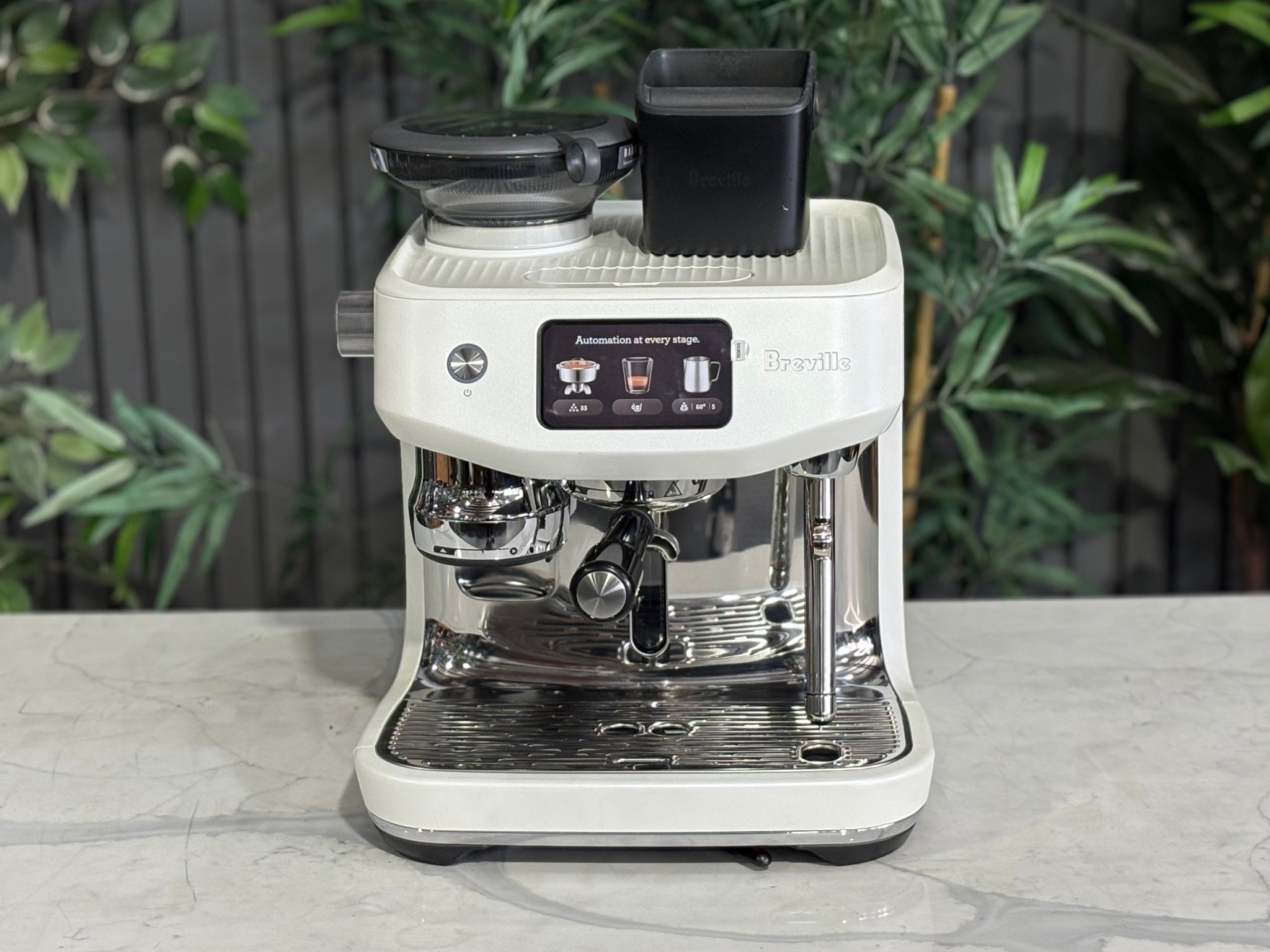 Breville Oracle Jet 1 Group Coffee Machine White - New, top-front perspective on a marble bench, featuring the 340g coffee hopper, touch screen display, and white espresso machine body.
