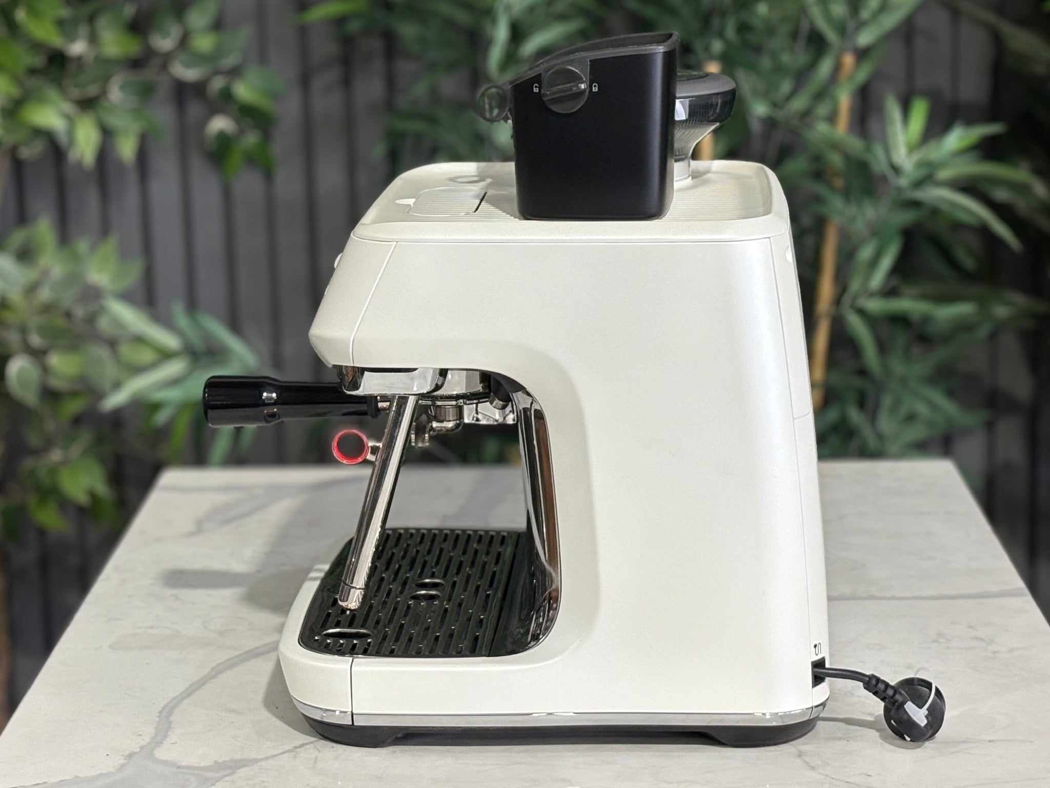 Breville Oracle Jet 1 Group Coffee Machine White - New, side view on a marble bench, highlighting the white body and AutoMilQ milk steamer of this 1 group espresso coffee machine.