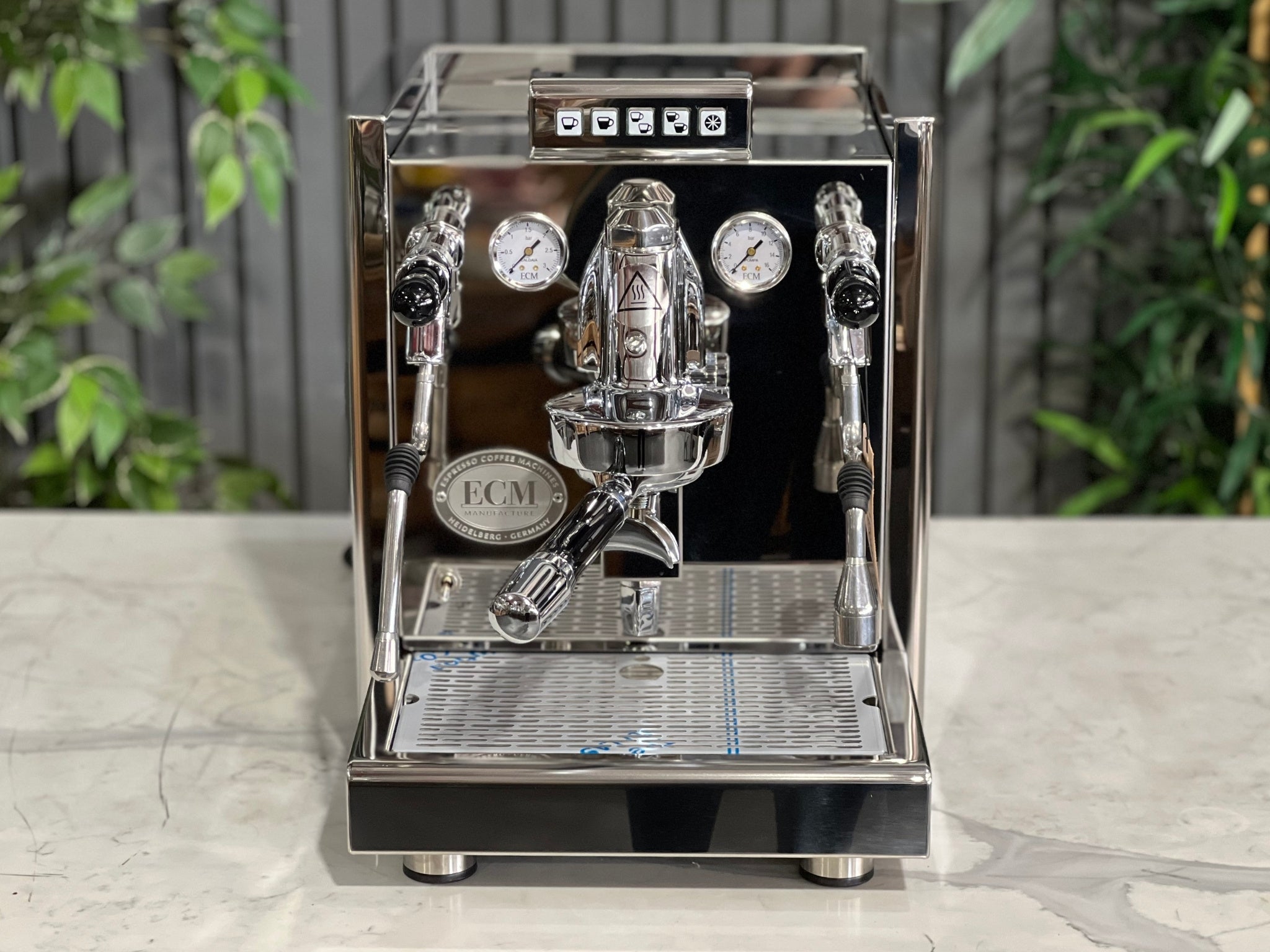 ECM Elektronika II Profi Rotary 1 Group Espresso Coffee Machine Stainless – New, front-facing view highlighting the E61 group head, steam wand, PID gauges, and cup tray on a marble bench with greenery behind.
