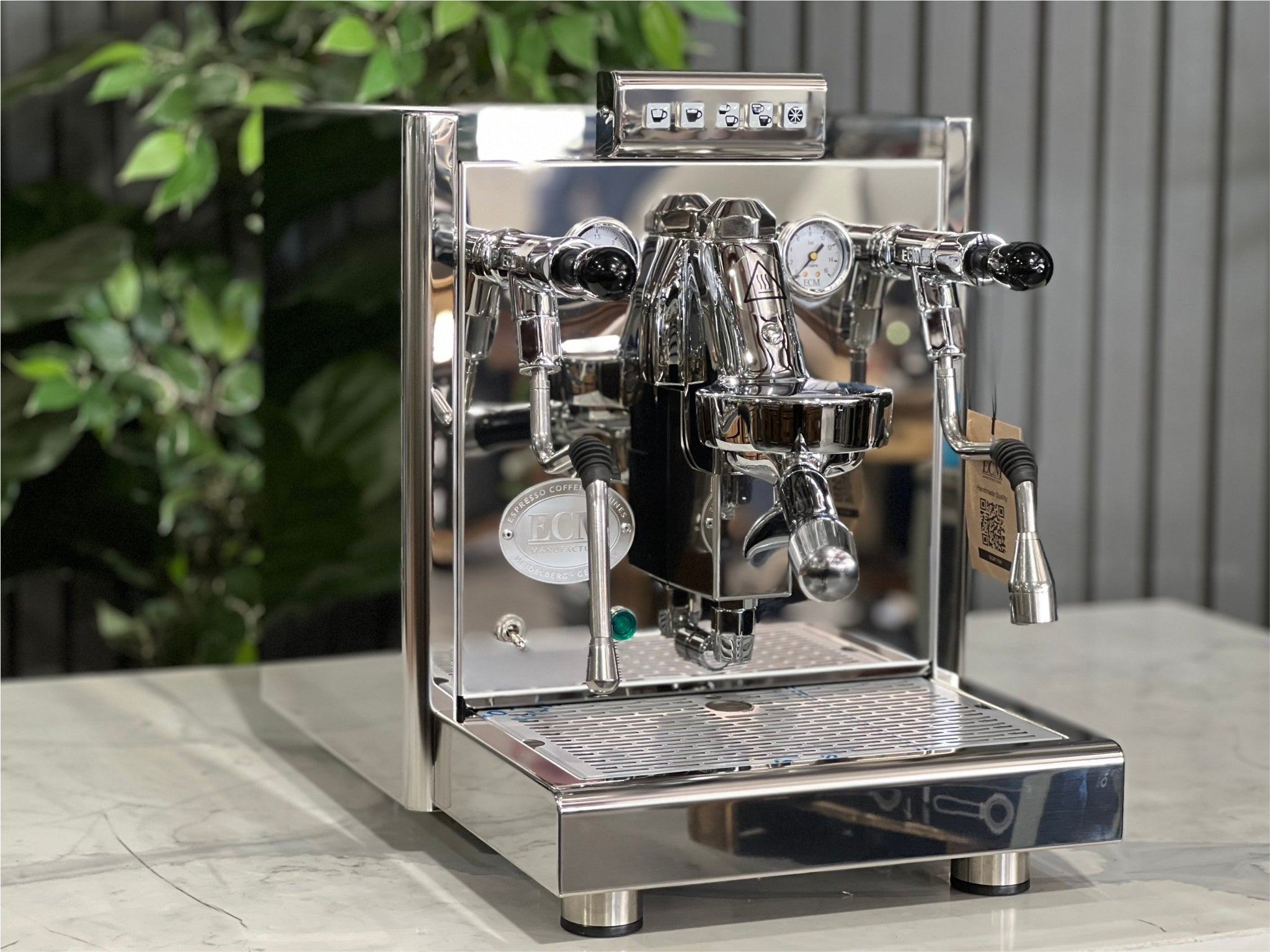 ECM Elektronika II Profi Rotary 1 Group Coffee Machine Stainless – New, angled view showing stainless steel body, E61 group head, steam wand, and cup warmer on a marble bench with greenery behind, perfect for a home espresso setup.