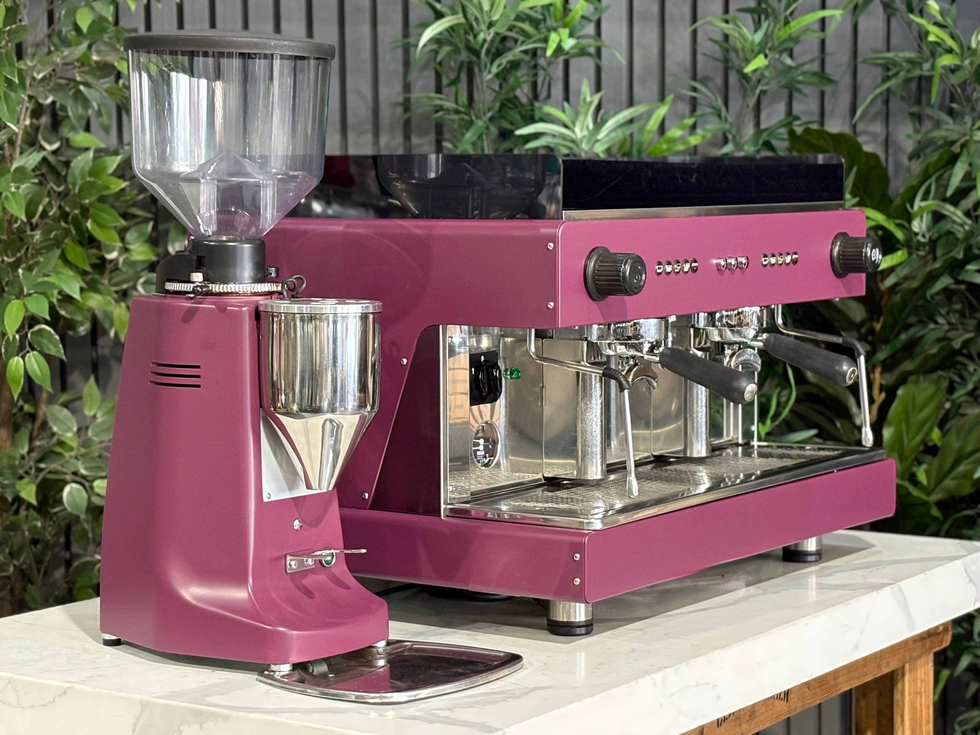 Wega Pegaso EVD 2 Group Coffee Machine & Mazzer Major Electronic Grinder in deep pink on a marble countertop