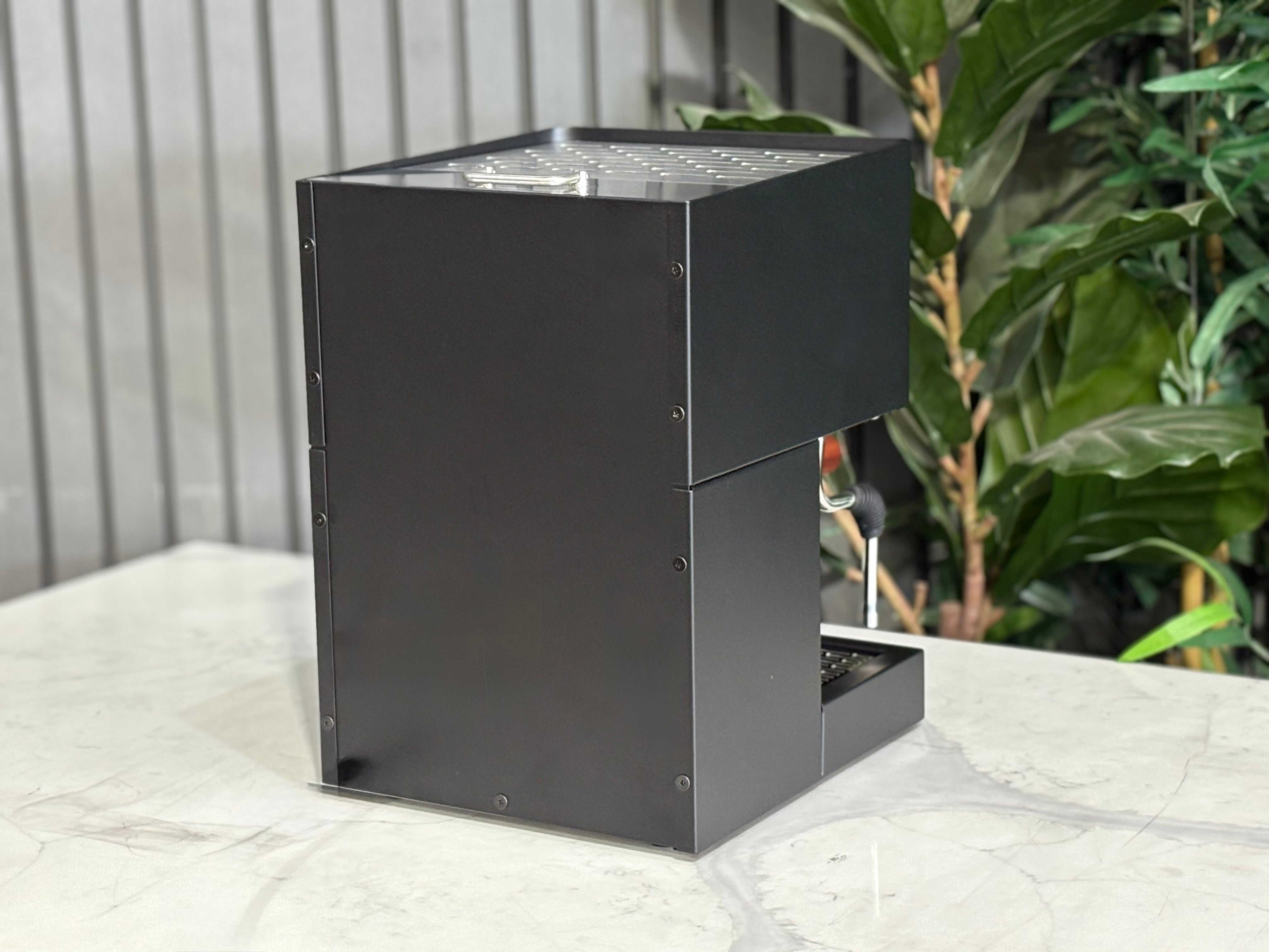 Essenza Nina 1 Group Coffee Machine Stainless showcasing its sleek design and compact features on a marble surface.