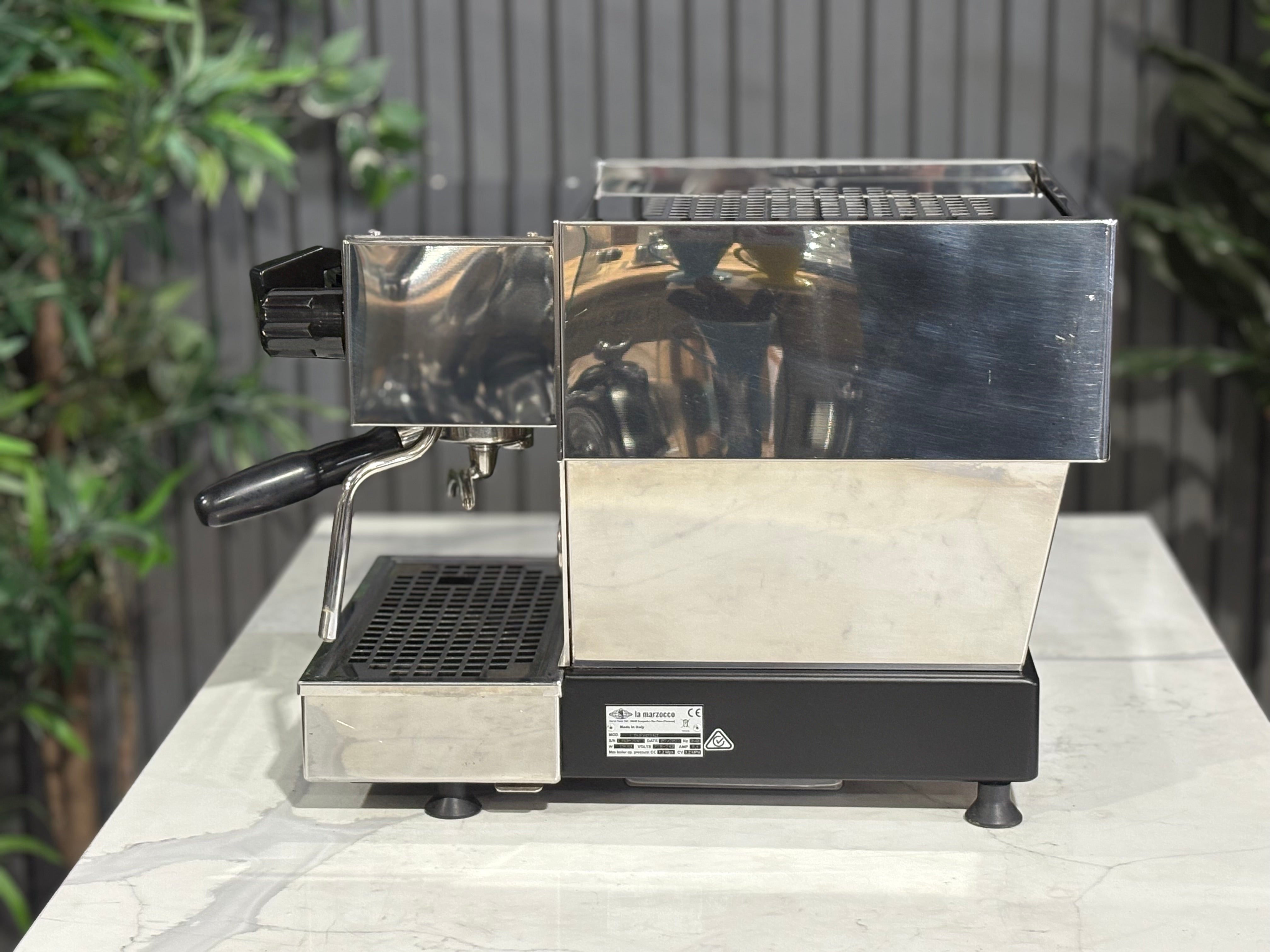 La Marzocco Linea Mini MP 1 Group Coffee Machine Stainless - Used side view on a countertop with greenery in background.