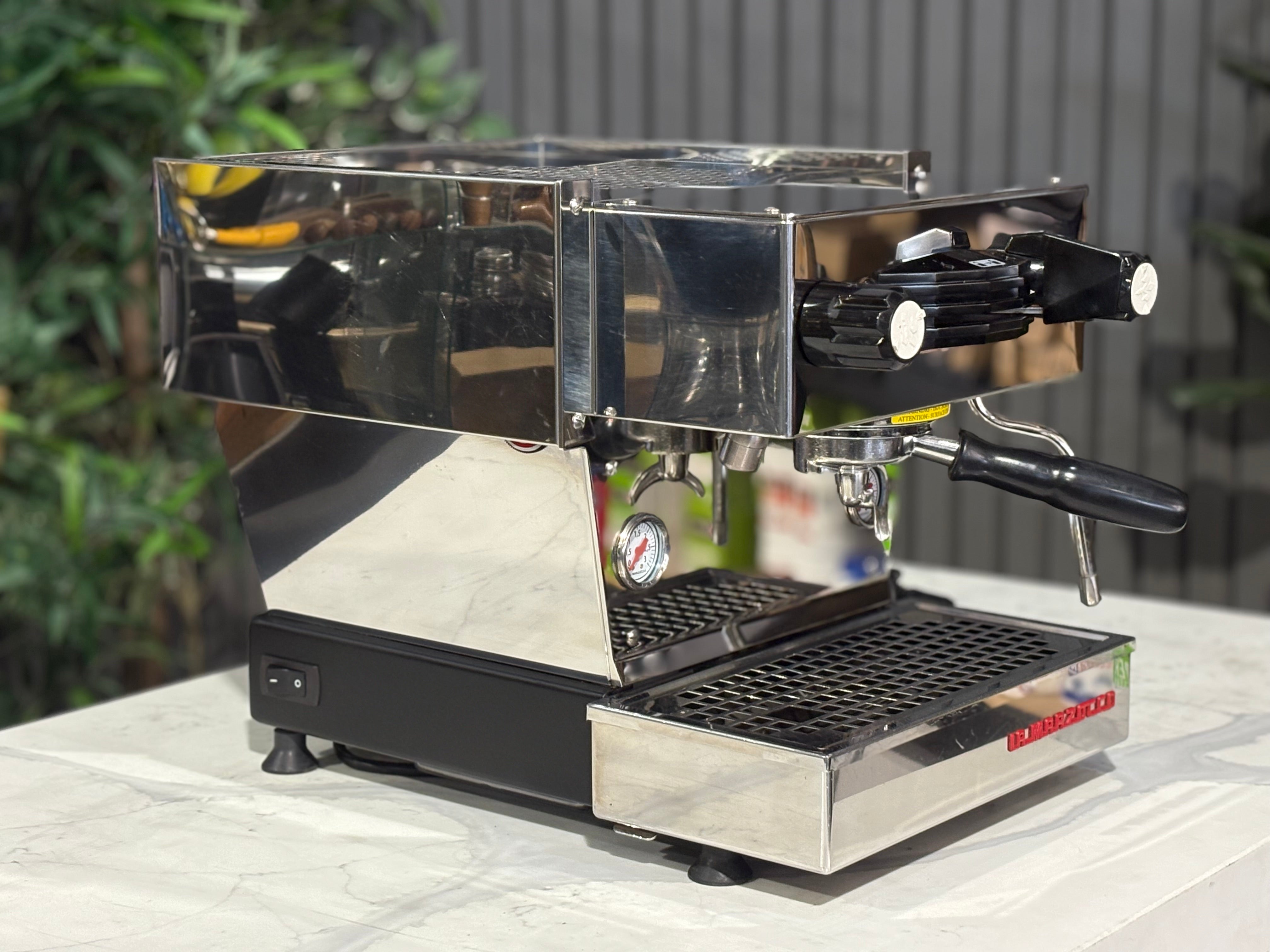 La Marzocco Linea Mini MP 1 Group Coffee Machine Stainless - Used showcased on a countertop with greenery in the background.