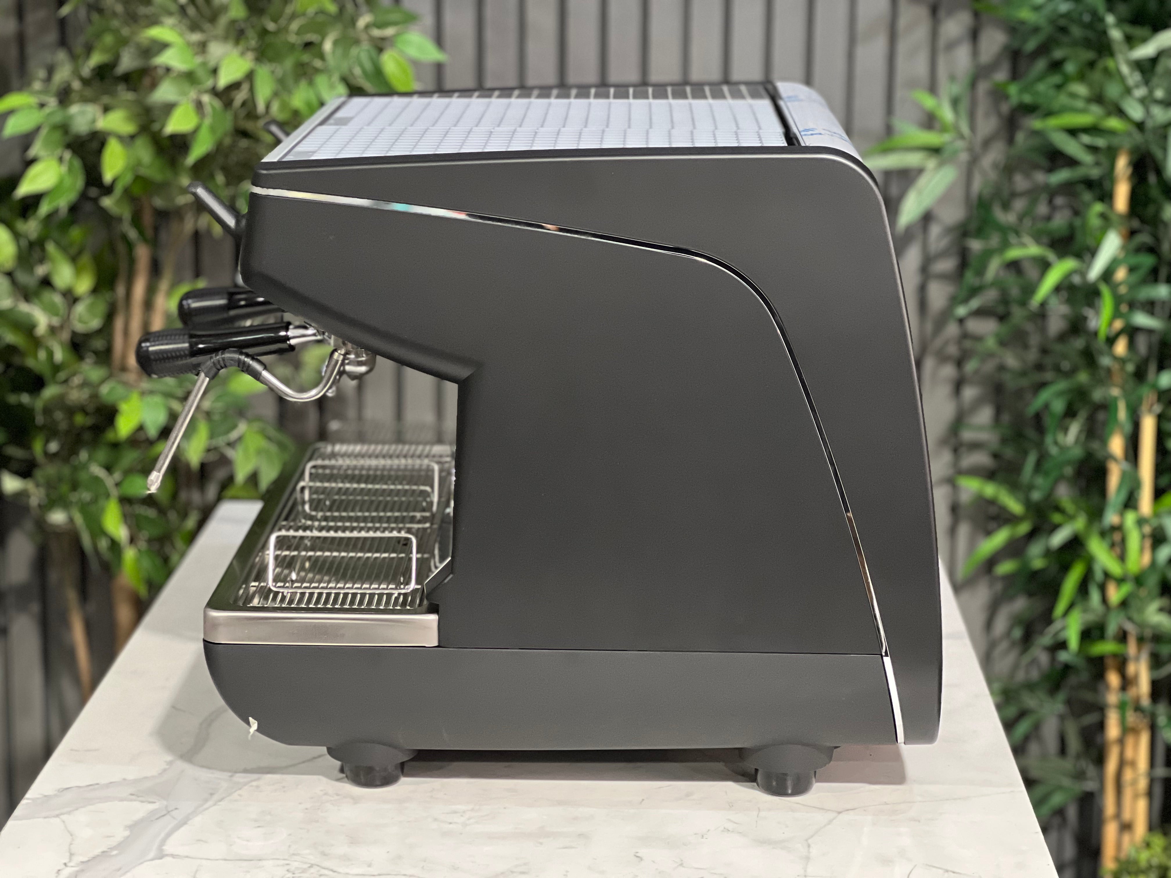 Nuova Simonelli Appia Life Compact Black 2 Group Espresso Machine side view with sleek design and trays
