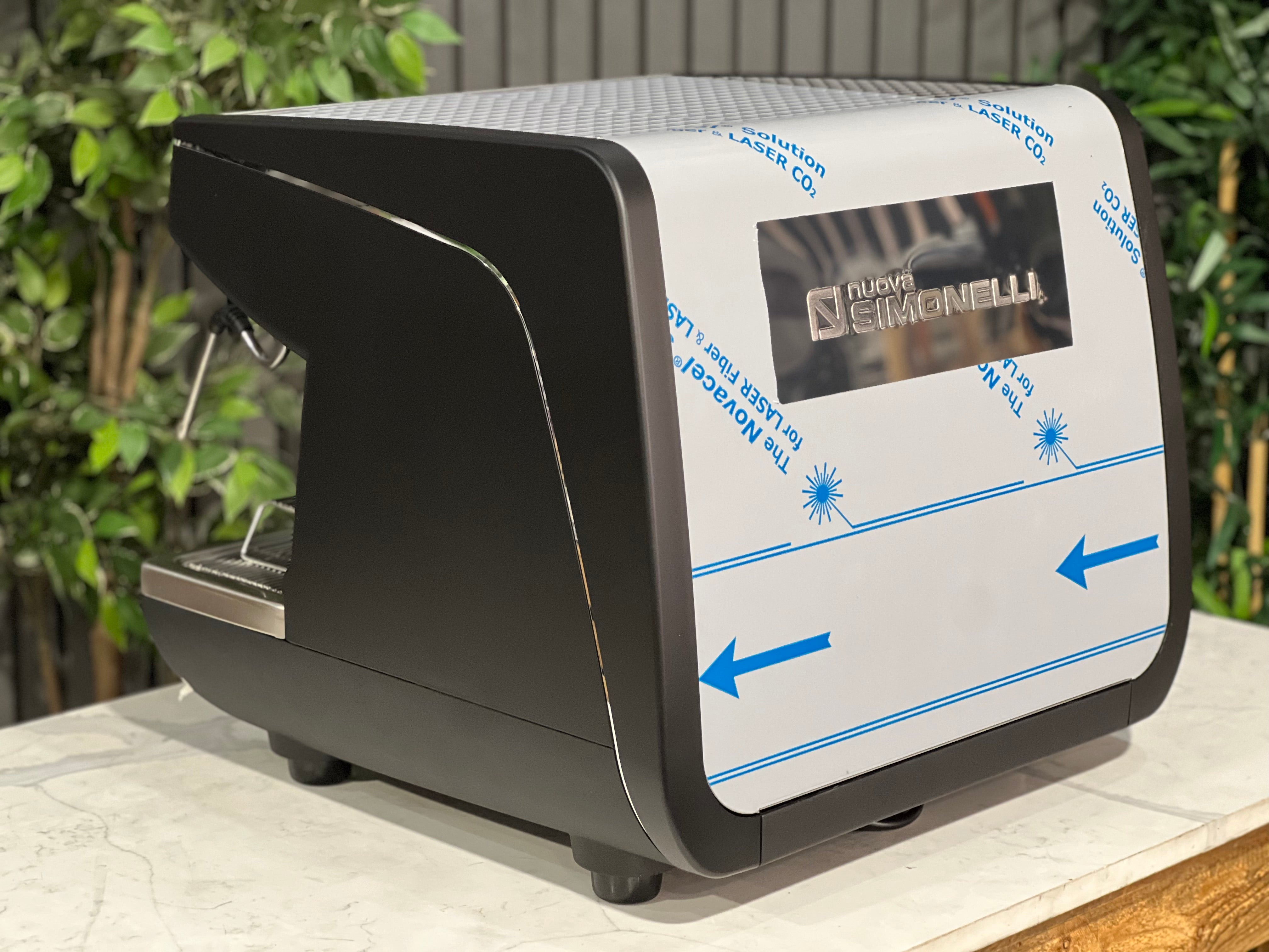 Nuova Simonelli Appia Life Compact Black 2 Group Espresso Machine displayed with protective covering.