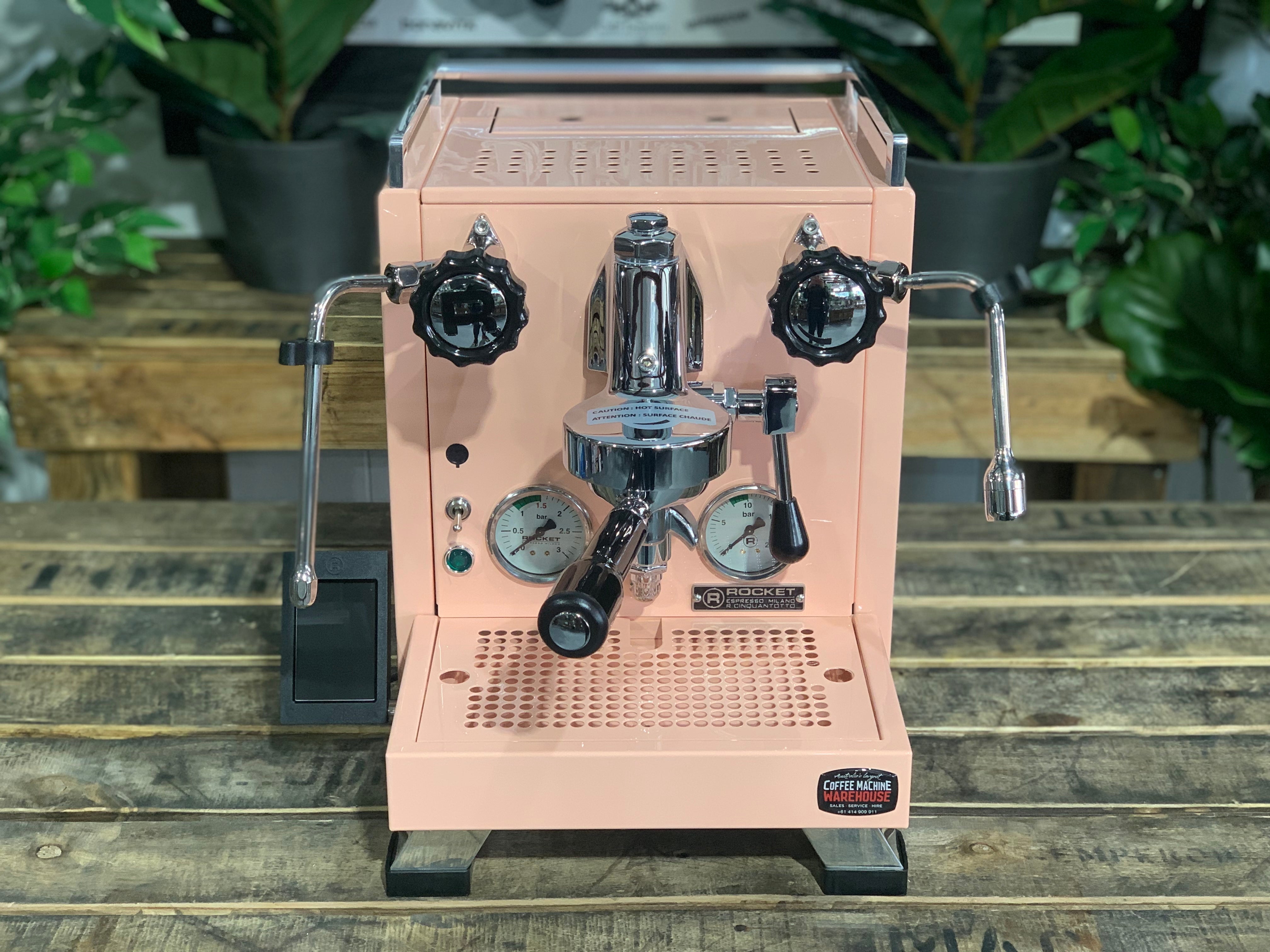 Rocket Cinquantotto R58 1 Group Coffee Machine Pink - New on a wooden table with green plants in the background.