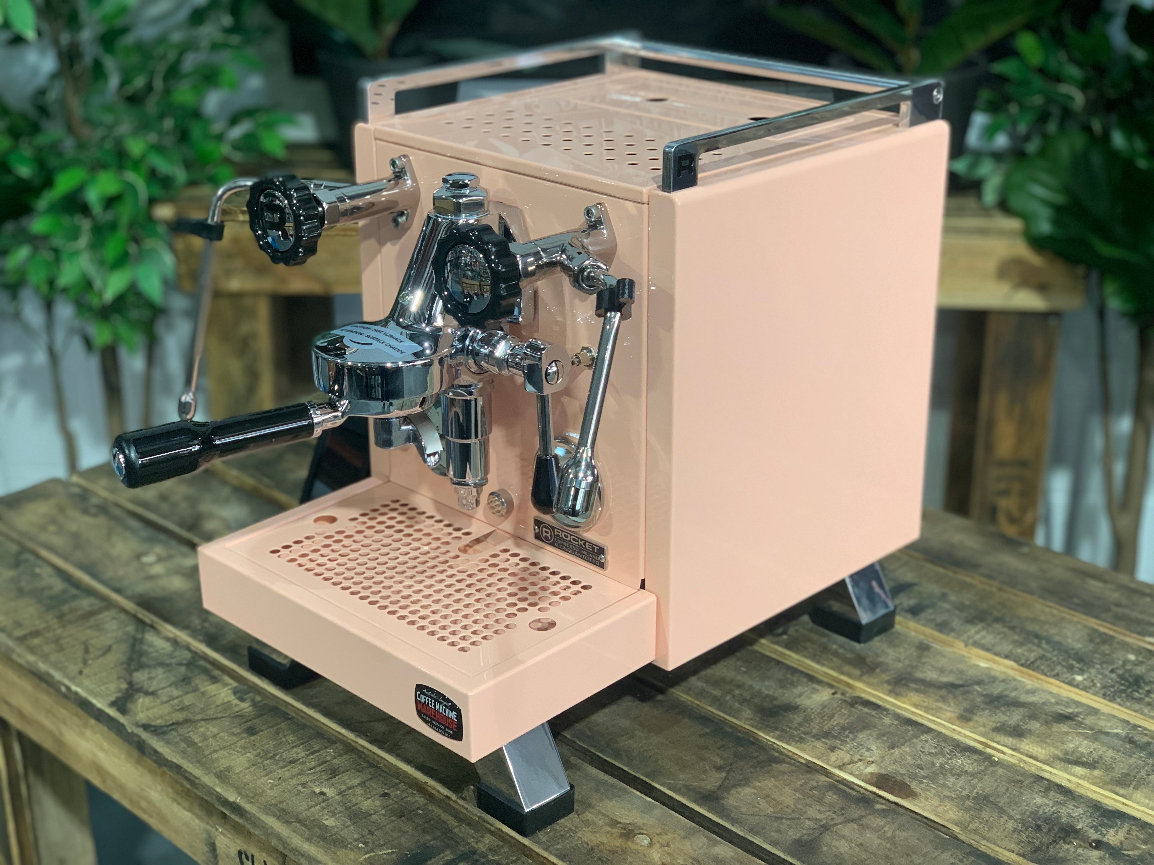 Rocket Cinquantotto R58 1 Group Coffee Machine Pink - New on a wooden counter with greenery in the background.