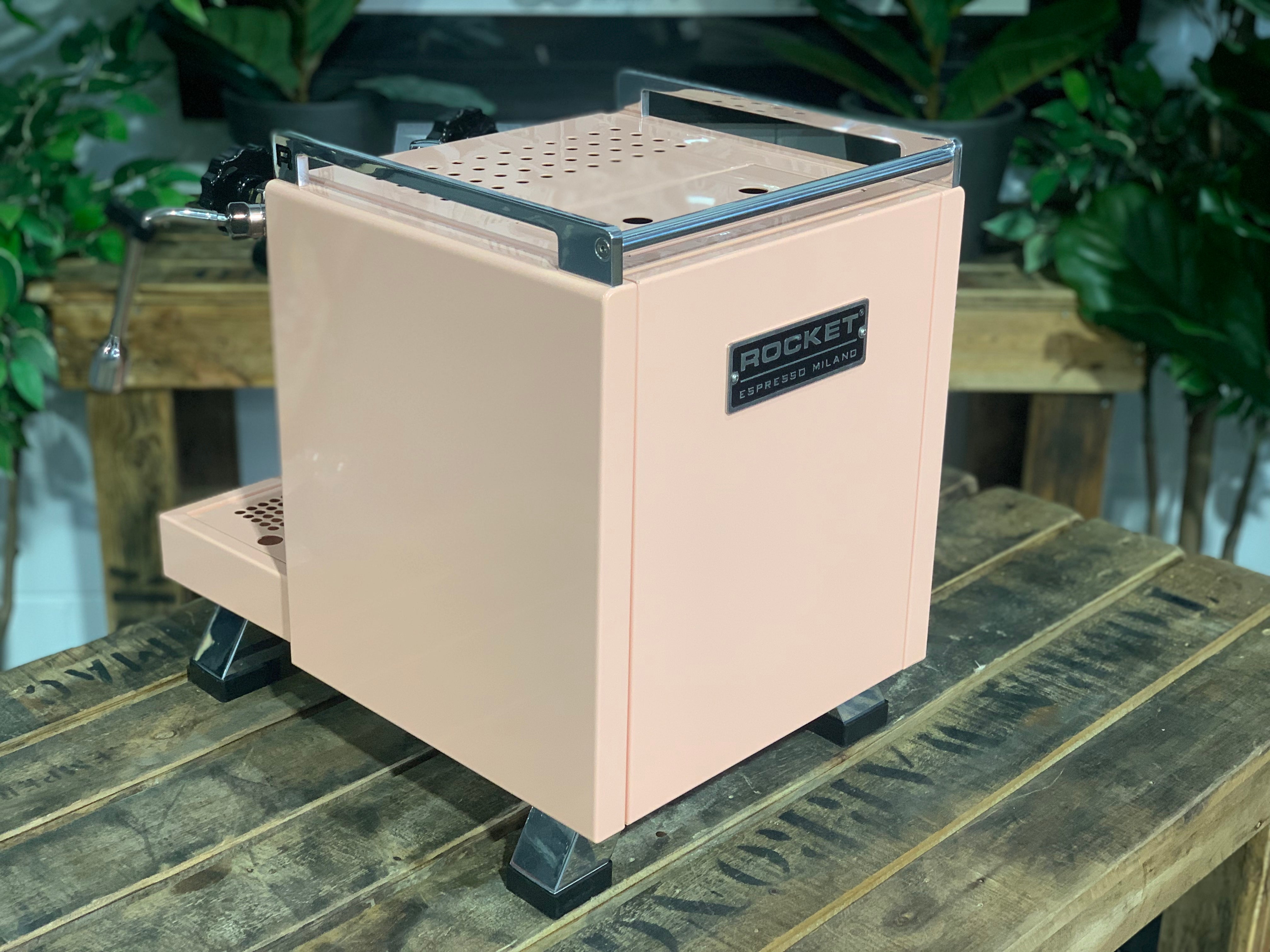 Rocket Cinquantotto R58 1 Group Coffee Machine Pink - New view on wooden table with greenery in the background.