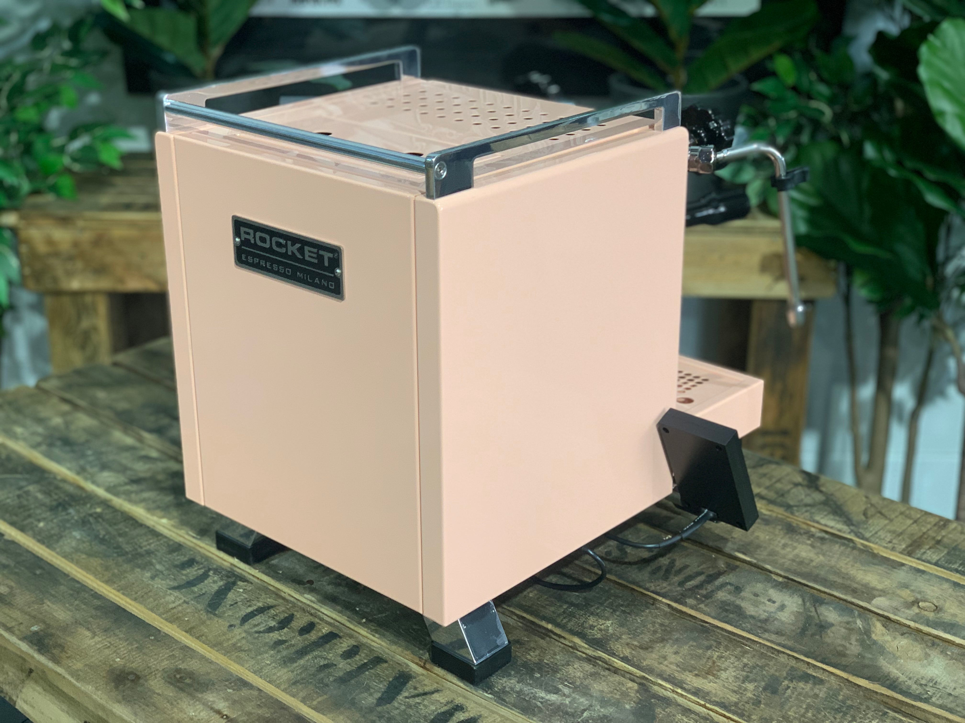 Rocket Cinquantotto R58 1 Group Coffee Machine Pink - New on a wooden table with greenery in the background.