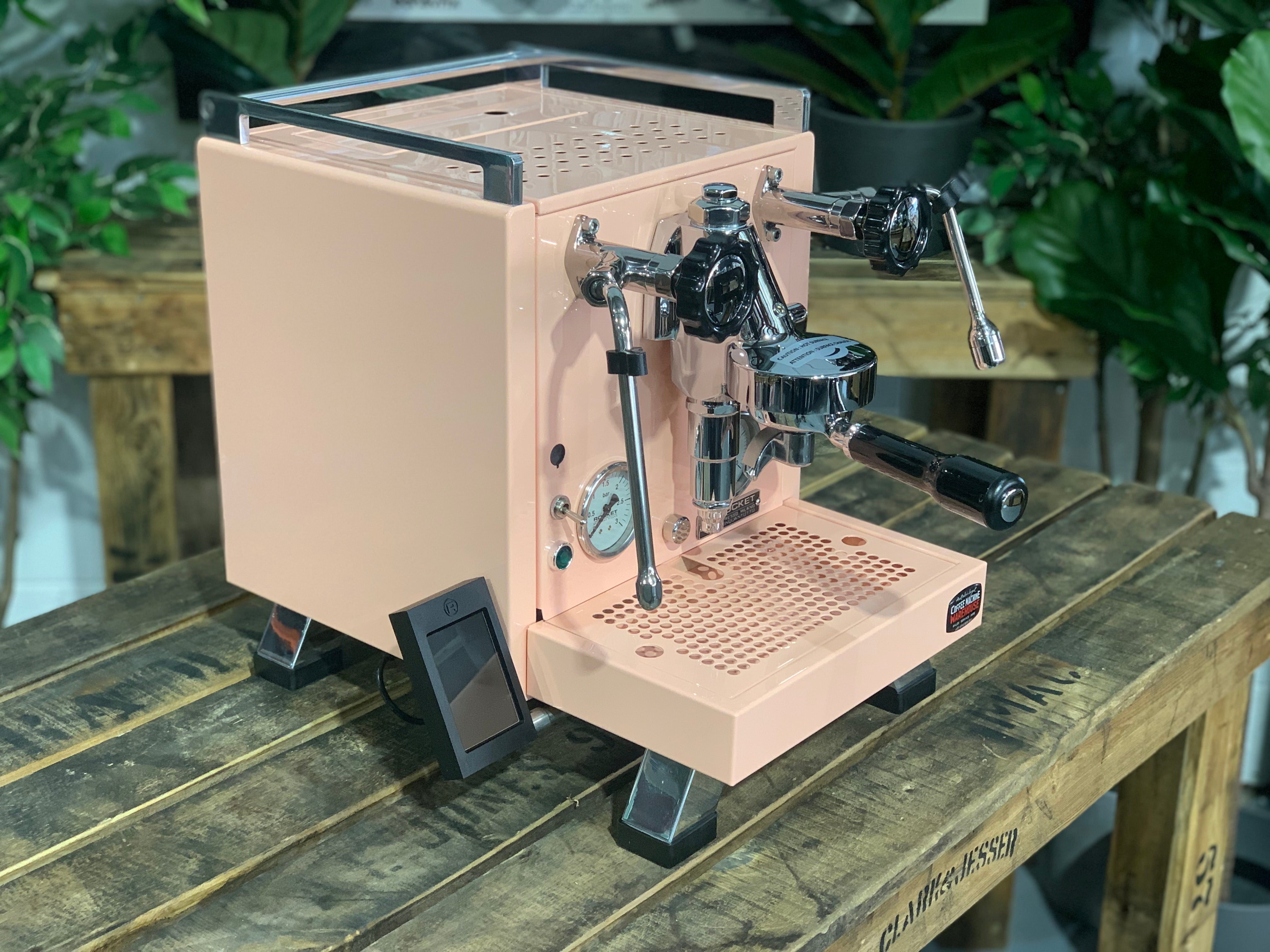 Rocket Cinquantotto R58 1 Group Coffee Machine Pink - New on a wooden table with green plants in background.