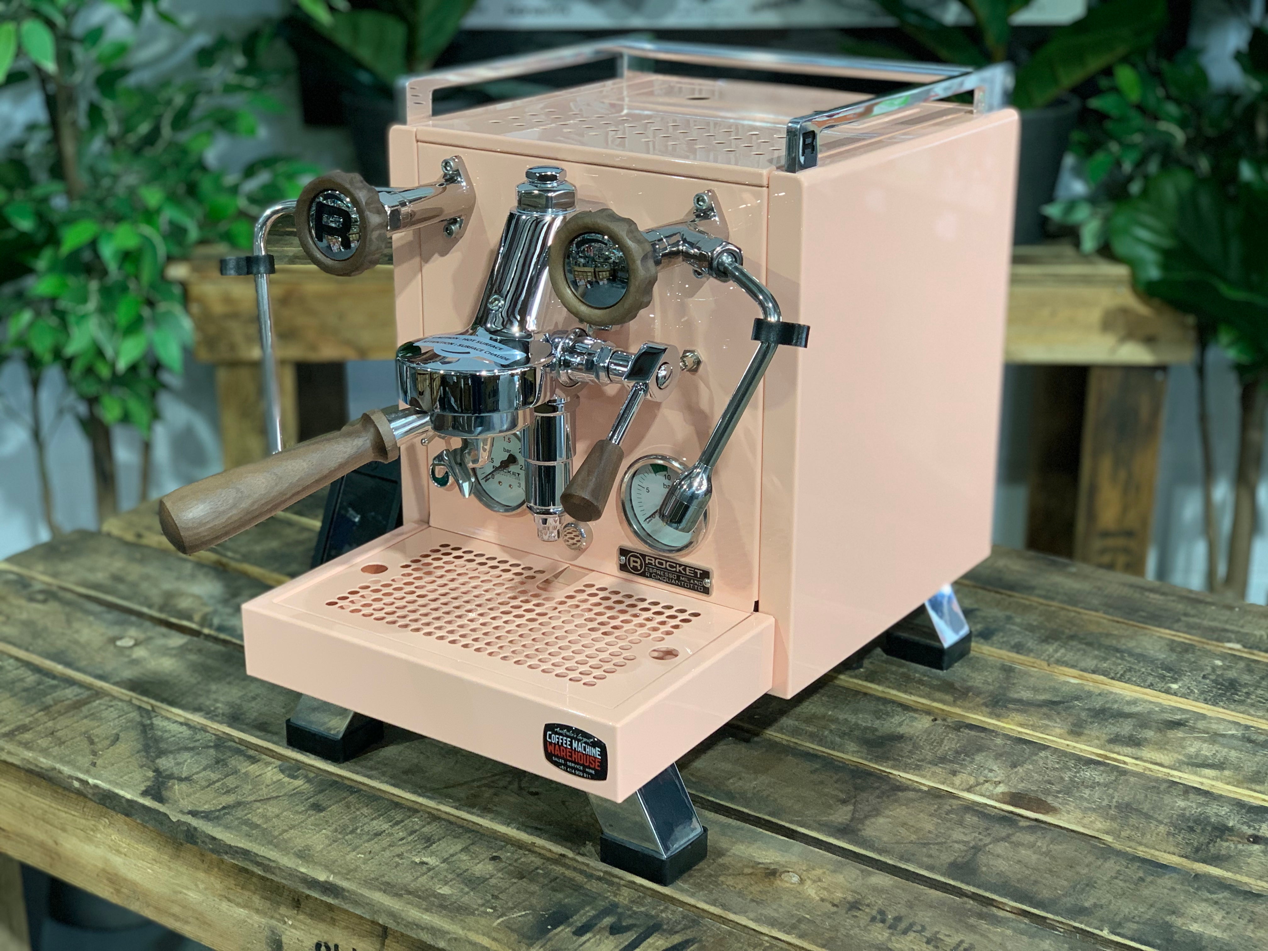 Rocket Cinquantotto R58 1 Group Coffee Machine - New in pink finish on wooden table with plants in background.