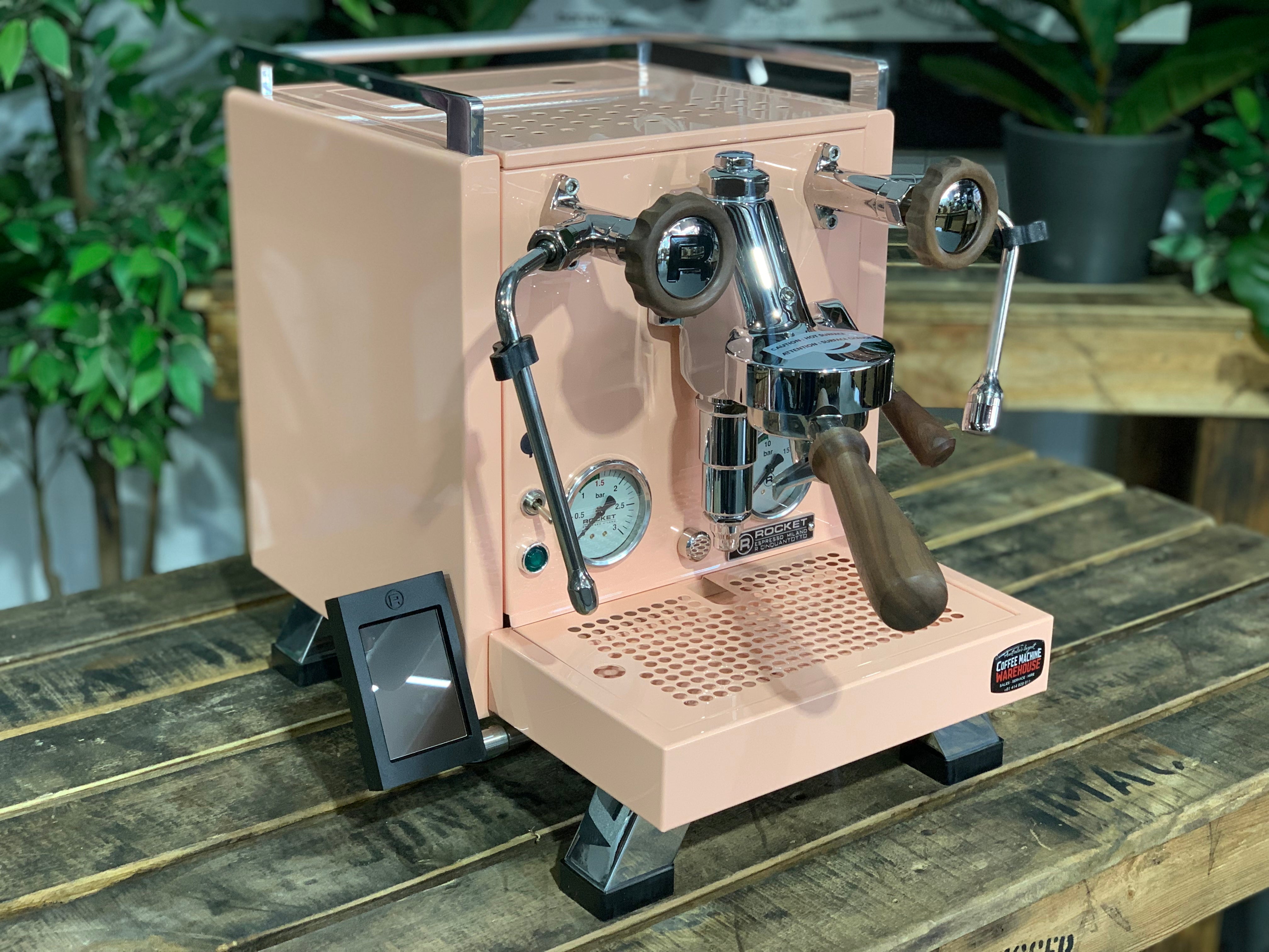 Rocket Cinquantotto R58 1 Group Coffee Machine - New in pink finish on wooden table with plants in background.